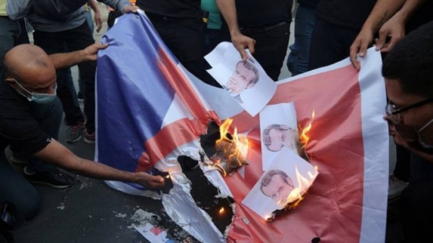 متظاهرون في رام الله يحرقون العلم الفرنسي