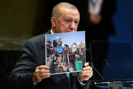 اردوغان حاملا صور اطفال غزة:"الشعب الفلسطيني لايقتل بالاسلحة فقط بل بالتجويع ايضا"